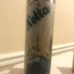 A tall glass with some type of liquid inside